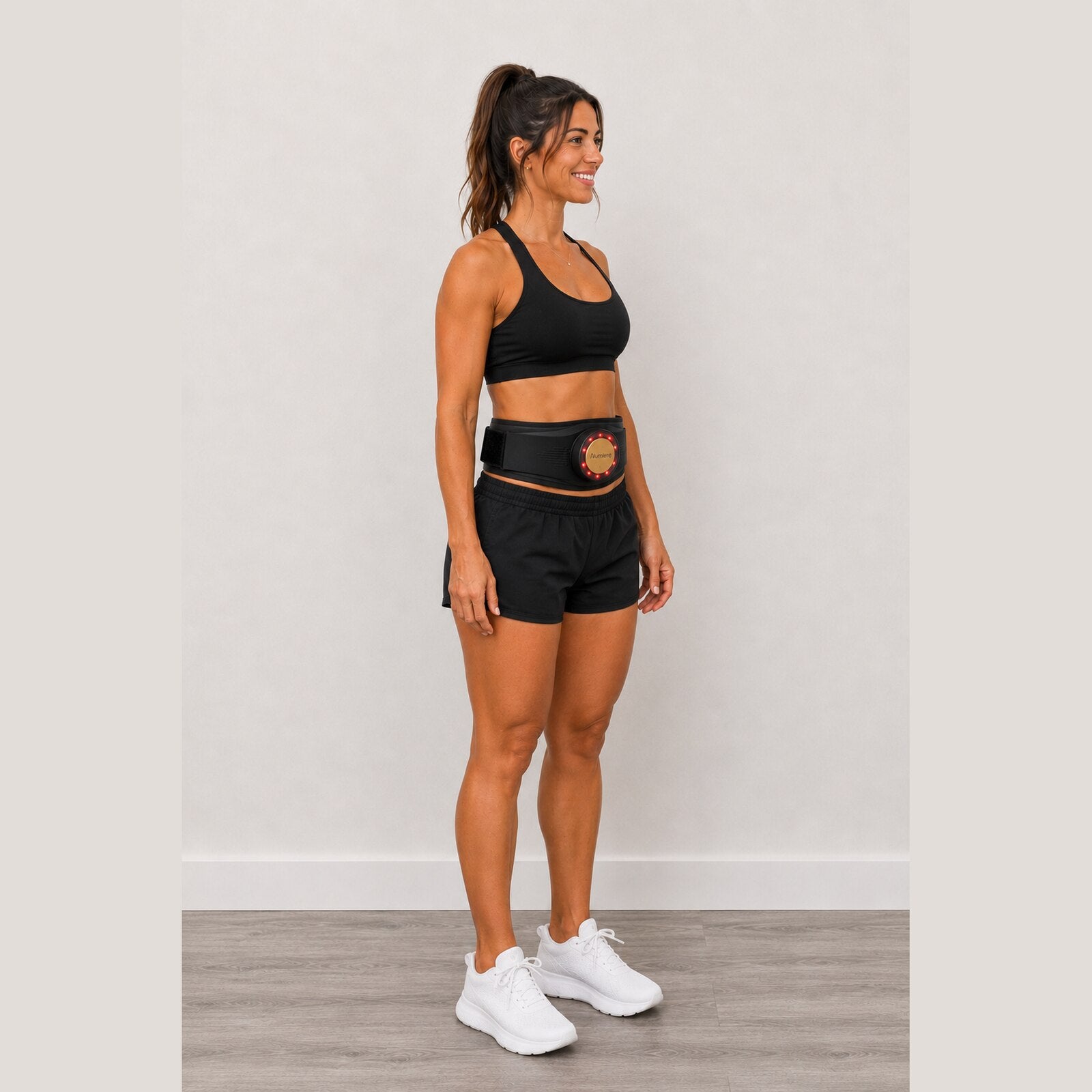 Full-length view of a woman in black sportswear wearing Body Keeper X